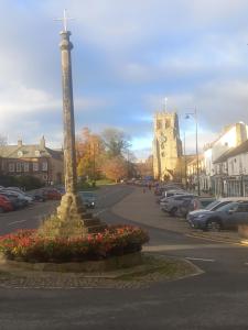 a street with a light pole in a parking lot at Clubhouse, North End, Bedale DL8 1AB in Bedale +7 photos