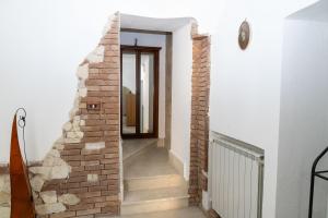 a brick staircase in a house with a mirror at View, Terrace & Comfort in Sant'Agata de' Goti in SantʼAgata deʼ Goti +34 photos