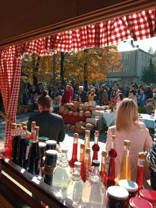 a group of people sitting at a table with bottles at Kraljska koliba - Kralje's Cottage in Andrijevica