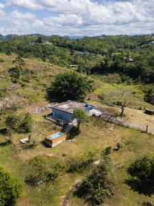 an aerial view of a house in a field at Pastoreo | River Trail | Generator | Morovis, PR in Ciales