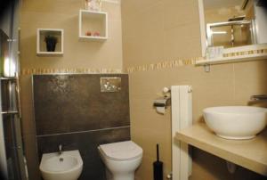 a bathroom with a toilet and a sink at Labanca's La Perla in Matera +3 photos