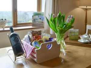 a box of food and flowers on a table at Hadrians Garden Villa in Bardon Mill