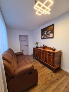 a living room with a couch and a table at Luci's House in Jucu de Mijloc