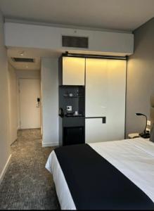 een hotelkamer met een bed en een koelkast bij Your Private Space in Soweto