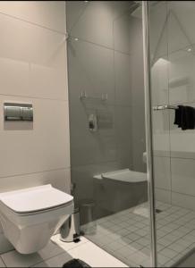 een badkamer met toilet en glazen douche bij Your Private Space in Soweto