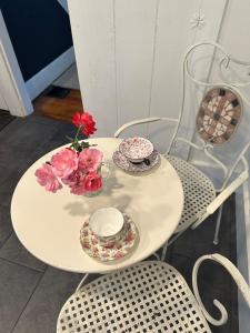 a white table with two plates and flowers on it at New Leeds listing Near Graces diner and Hudson! in Catskill