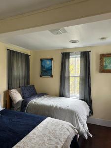 a bedroom with two beds and a window at New Leeds listing Near Graces diner and Hudson! in Catskill