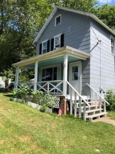 a gray house with a porch and a yard at New Leeds listing Near Graces diner and Hudson! in Catskill +16 photos