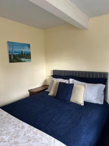 a bedroom with a large bed with blue sheets at New Leeds listing Near Graces diner and Hudson! in Catskill