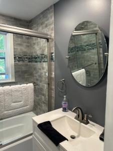 a bathroom with a sink and a mirror at New Leeds listing Near Graces diner and Hudson! in Catskill +16 photos