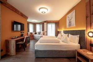 Postel nebo postele na pokoji v ubytování Hotel Chalet Sas Morin