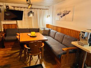 a living room with a couch and a table at Ski in & Ski out Apartment at Chalet Heinrich in Sonnenalpe Nassfeld