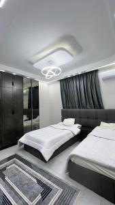 a bedroom with two beds and a mirror at Three-bedroom apartment in Mohandessin in Cairo