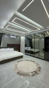 a bedroom with a bed and a rug on the floor at Three-bedroom apartment in Mohandessin in Cairo