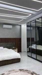a bedroom with a large bed and a mirror at Three-bedroom apartment in Mohandessin in Cairo