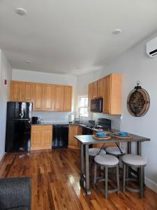 a kitchen with wooden cabinets and a table with stools at The Harrison in Harrison