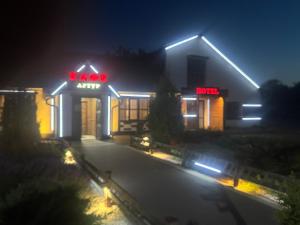 ein Kogiarma-Restaurant bei Nacht mit eingeschalteter Beleuchtung in der Unterkunft Артур in Berdychiv