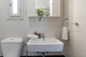 um banheiro branco com um vaso sanitário e uma pia em Villa Marianthy Kefalonia em Zambelláta mais 36 fotografias