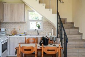 eine Küche mit Tisch und Treppe in der Unterkunft Villa Marianthy Kefalonia in Zambelláta