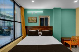 Ένα ή περισσότερα κρεβάτια σε δωμάτιο στο Hotel O MSR Grand Hotel