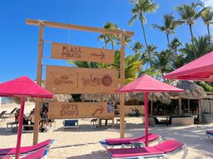 a group of chairs and umbrellas on a beach at Condo very close beach in Punta Cana +36 photos