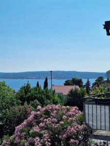 a view of the water from a balcony with flowers at Seaside Apartment Bubi in Crikvenica
