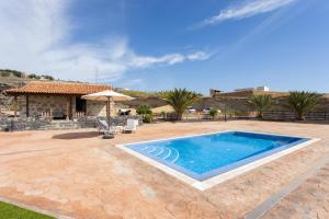 a swimming pool in front of a house at Casa La Tosca in San Miguel de Abona
