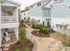 a backyard of two houses with a patio and a garden at 412A The Inlet House in Virginia Beach
