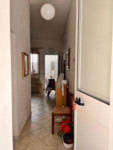 a hallway with a door leading to a living room at House beach in San Pietro in Bevagna