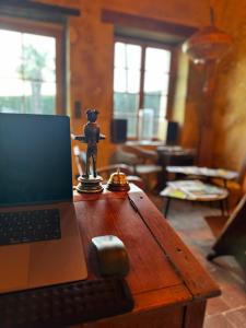 a laptop computer sitting on a wooden table in a room at Le Relai Valdieu in Courgeon
