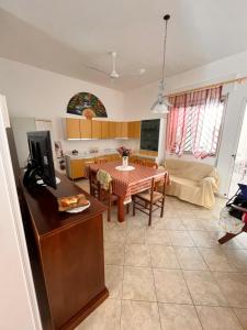 a kitchen and a living room with a table at House beach in San Pietro in Bevagna