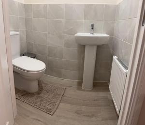 a bathroom with a toilet and a sink at Home 4 Home short stay in Warren +6 photos