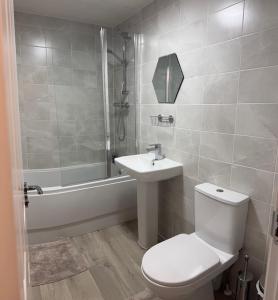 a bathroom with a toilet and a sink and a shower at Home 4 Home short stay in Warren