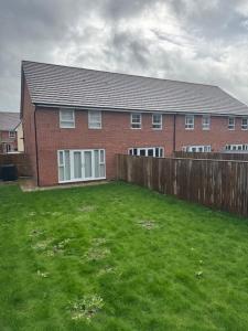 a brick house with a green yard in front of it at Home 4 Home short stay in Warren