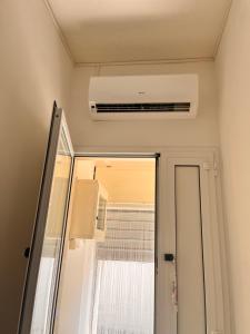 a bathroom with a ceiling fan and a mirror at House beach in San Pietro in Bevagna