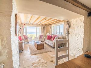 a living room with a view of the ocean at Tir A Mor in Nefyn