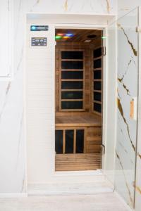 a door into a closet with a window at Chalet Bos en Pootjes in Lanaken