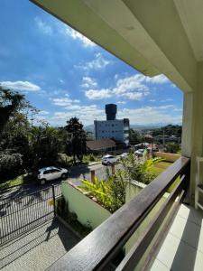 a balcony with a view of a parking lot at Hostel e Pousada Vó Lili in Joinville