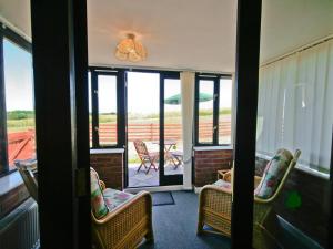 a room with a porch with chairs and a table at Sally's Nest - E3042 in Blyford