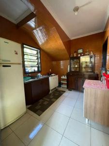 a kitchen with a refrigerator and a counter top at Hostel e Pousada Vó Lili in Joinville