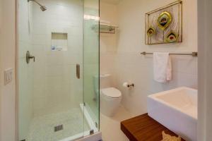 a bathroom with a shower and a toilet and a sink at Sunset Beach in Encinitas +16 photos