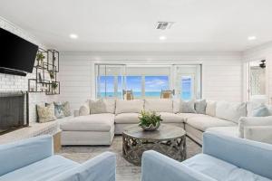 a living room with a white couch and a fireplace at Seaside Retreat in Santa Rosa Beach