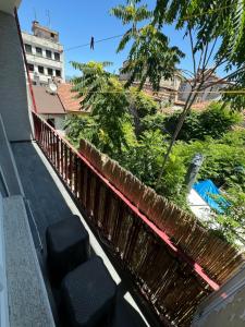 a balcony with a fence and some bushes and trees at Asmaaltı GUEST HOUSE in Bursa