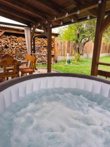 een hot tub in de achtertuin met een pergola bij Velencei Odú in Velence