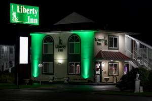 a lit up house with a neon sign in front of it at Liberty Inn Absecon Atlantic City in Galloway
