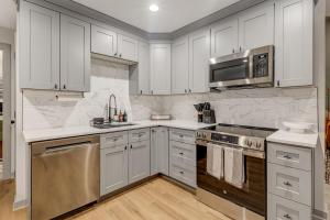 a kitchen with white cabinets and stainless steel appliances at 5BR Private Ranch Pet Friendly in Wake Forest