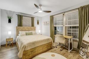 a bedroom with a bed and a desk and windows at 5BR Private Ranch Pet Friendly in Wake Forest +61 photos