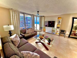 a living room with a couch and a table at Stylish Designed 1BR Coral Beach by Stay Here PR in San Juan