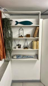 a book shelf with a blue fish on it at The Pearl at Strand in Strand