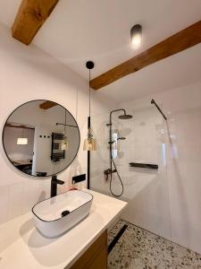a bathroom with a sink and a shower and a mirror at Blisko in Kuźnica +8 photos
